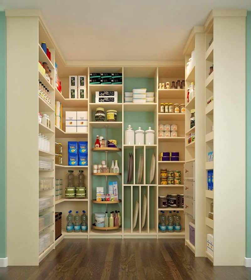 turquoise walk-in pantry walls with 4-tiered lazy susan shelf organizer and 3 off-white drawers with rose gold knobs and five frosted white plastic drawers with three white porcelain lidded apothecary jars on box shelf