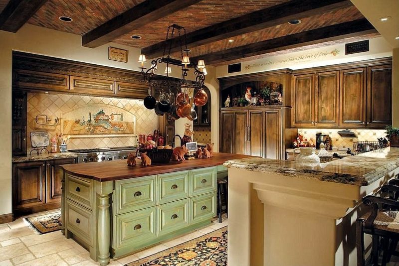 tumbled porcelain tile flooring with persian rugs and sage green kitchen island with butcher block top and hardwood range hood crown molding matching kitchen cabinets