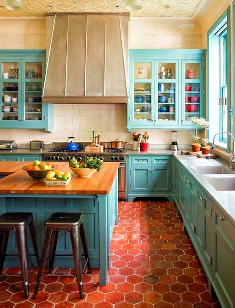 two sets of turquoise three-door glass cabinets and solid white Corian countertop with integrated double sink and drain board with clay brick hexagonal flooring and L-shaped wooden island with high gloss top finish and textured ceiling pattern